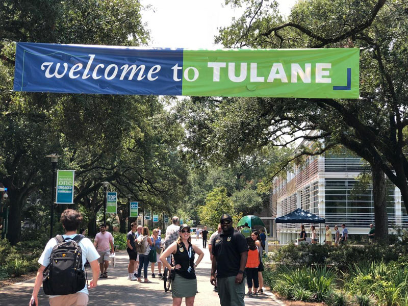 Meredith Beers and Donald Veals standing under Welcome to Tulane banner on uptown campus