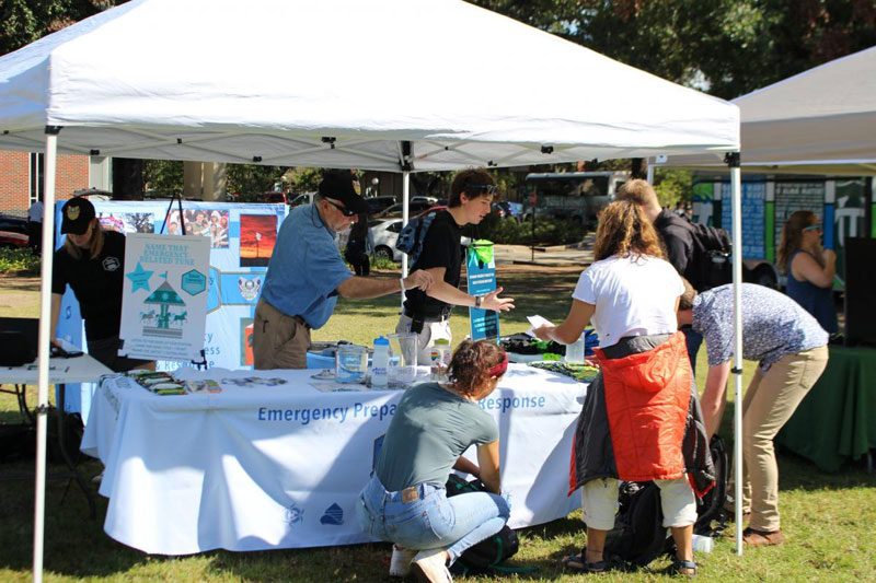 Team members at Information tent on campus
